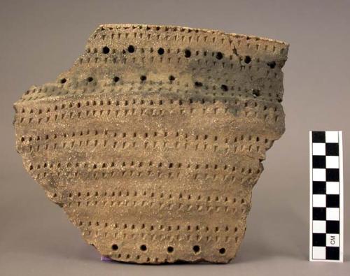 Rim sherd-pit and comb ornamented
