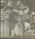 Girl standing next to stone structure, possibly Antigua