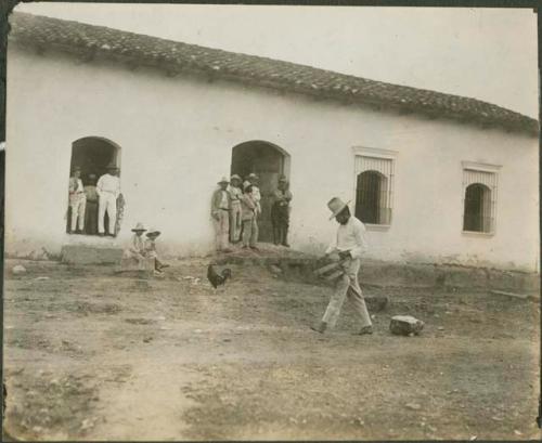 People outside white building in Copan