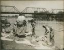 Women washing clothing and bathing in the river, possibly Zacapa