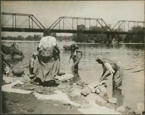 Women washing clothing and bathing in the river, possibly Zacapa