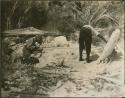 Two men examining temple ruins in Tulum