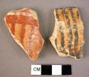 Ceramic rim sherd, black on buff ripple des, worn