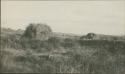 Men standing around ruins in Quiche