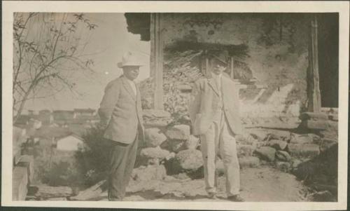 Two men standing outside building, possibly Santo Tomas Chichicastenango