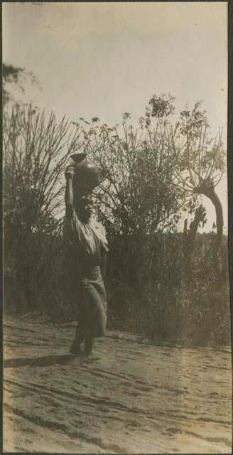 Woman carrying pottery on her head, possibly Solola