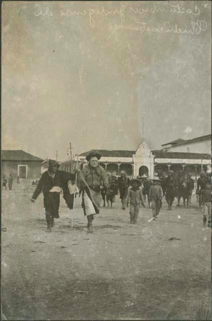 Group walking in village, possibly Chimaltenango