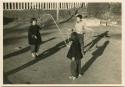 Children jumping rope in temple yard