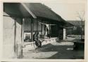 Children sitting in front of house