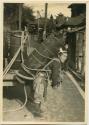 Man carrying barrel on his back