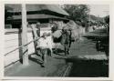 Man with horse hauling load of rice