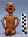 Figurine, micaceous ceramic, seated human, perforated features, mended