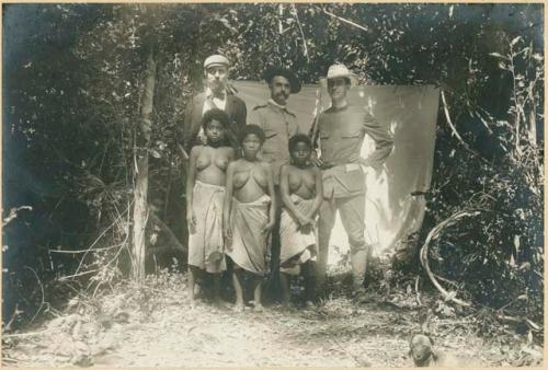 Three women from Bataan standing in front of three American men