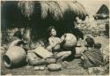 Igorot woman smoothing and expanding a completed pot
