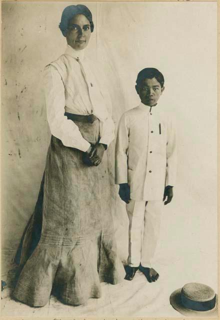 Igorot boy posed with Mrs. Jenks