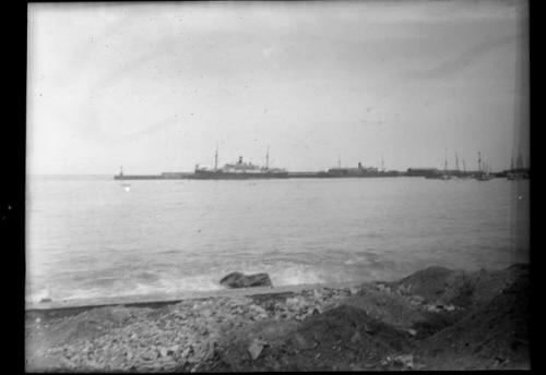 Boats on water seen from the shore