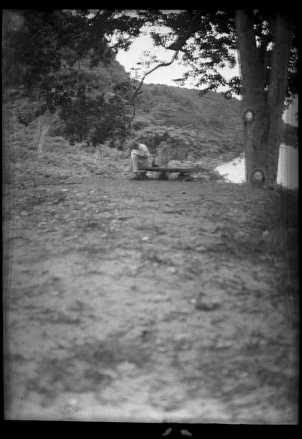 Man sitting on bench along shoreline