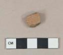 Unglazed redware vessel body fragment, visible temper, uneven firing, likely North Devon gravel tempered ware