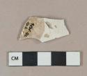Undecorated whiteware vessel body fragment, white paste, crazed