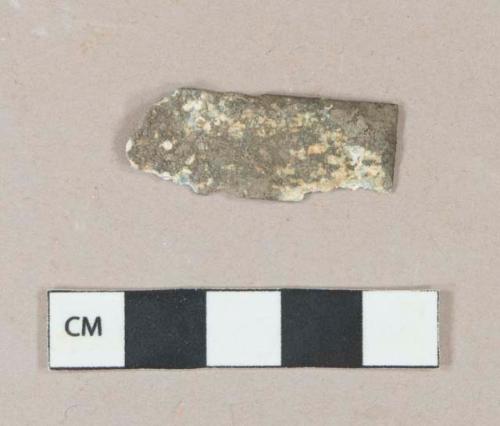 Lead alloy sheet fragment, heavily corroded