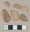 Unidentified mammal bone fragments; 2 unidentified unglazed ceramic fragments, visible temper, buff paste
