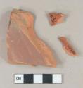 Dark brown painted, unglazed redware vessel body fragments, 1 with dark brown lead glaze