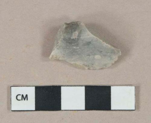 Light gray flint worked stone, likely scraper