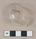Colorless vessel glass fragment, likely bottle shoulder, mold seam