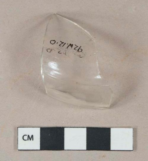 Colorless vessel glass fragment, likely bottle shoulder, mold seam