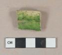 Bright green lead glazed earthenware vessel rim fragment, light buff paste, possible borderware