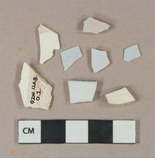 3 undecorated creamware vessel body fragments, buff paste; 4 white undecorated tin-glazed earthenware vessel body fragments, 2 just glaze, 1 buff paste, 1 red paste; 1 undecorated white porcelain vessel body fragment, white paste