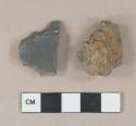 2 stone fragments, 1 dark gray slate, 1 gray granite