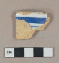 Blue on white handpainted tin-glazed earthenware vessel rim fragment, buff paste