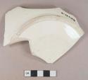 Undecorated creamware vessel base fragment, light buff paste, likely bowl or soup plate