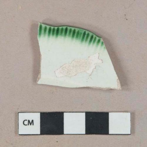 Earthenware, refined, pear;ware; green shell-edged, rim fragment, white paste