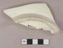 Undecorated creamware vessel base fragment, light buff or white paste