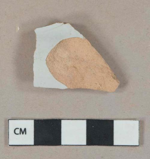 White undecorated tin-glazed earthenware vessel body fragment, light orange buff paste