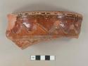 Earthenware, lead glazed, red exterior, brown interior; rim sherd, inscribed decoration