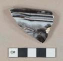 Black flow black pearlware vessel rim fragment, white paste