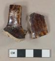 Brown mottled lead glazed earthenware vessel body and handle fragments, buff paste