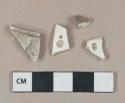 Undecorated whiteware vessel body and rim fragments, white paste