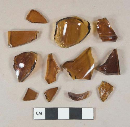 Amber glass vessel body, base, and finish fragments