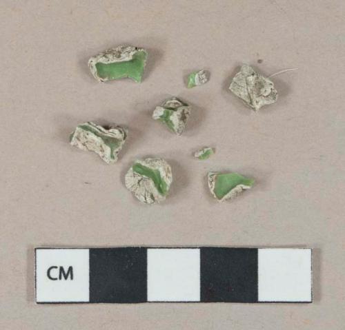 Green plastic fragments, white encrustations