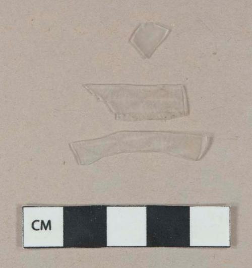 Colorless clear thin molded plastic fragments, possible drink cup fragments