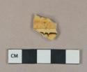 Brown combed slip decorated yellow ware vessel body fragment, buff paste