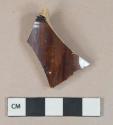 Brown lead glazed earthenware vessel body fragment, buff paste, likely rockingham type