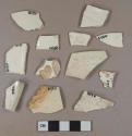 Undecorated creamware vessel body, rim, and base fragments, white or light buff paste