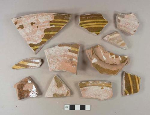 Earthenware, slipware, North Midlands type, yellow and blue on brown; sherds, unglazed exterior, trailed slip design