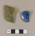 Blue bottle glass fragment; green bottle glass fragment, possible folded rim