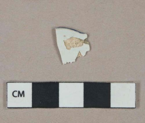 Blue on white decorated pearlware vessel rim fragment, white paste, likely shell-edged